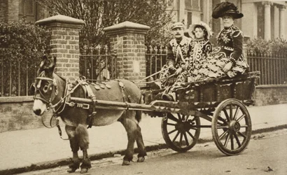 A donkey barrow transports a wealthy costermongers family